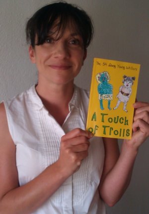 A proud teacher with the proof copy of her class's work